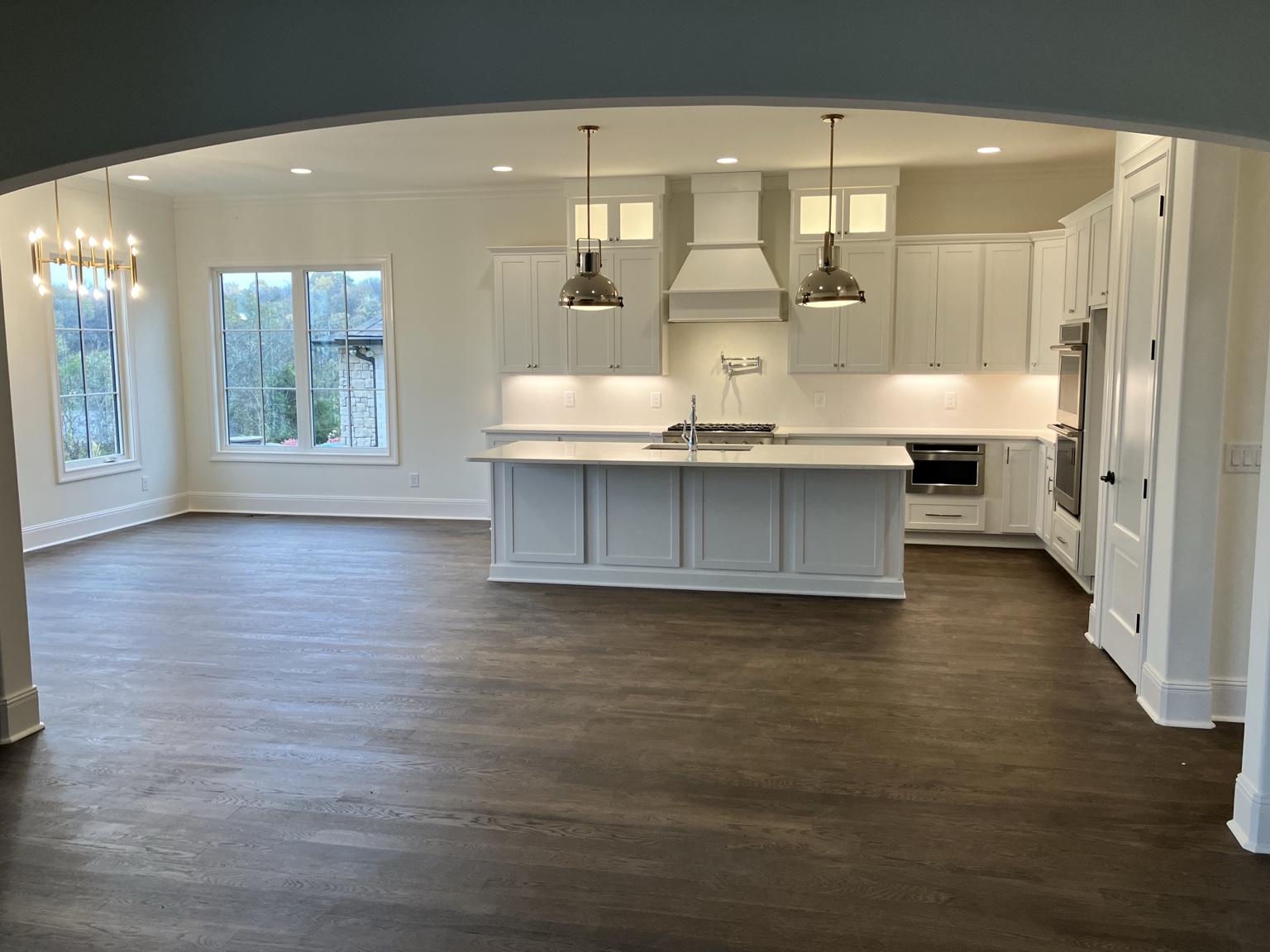 Finished white kitchen with a large island and custom cabinetry