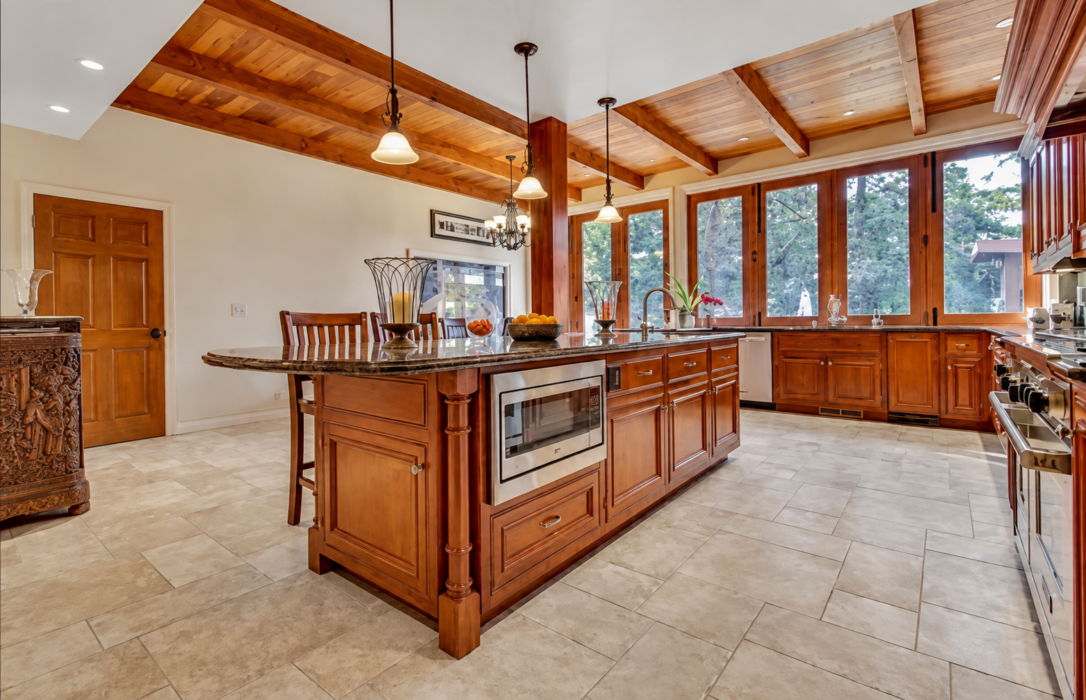 JC Construction kitchen renovation with exposed wood beams and large windows